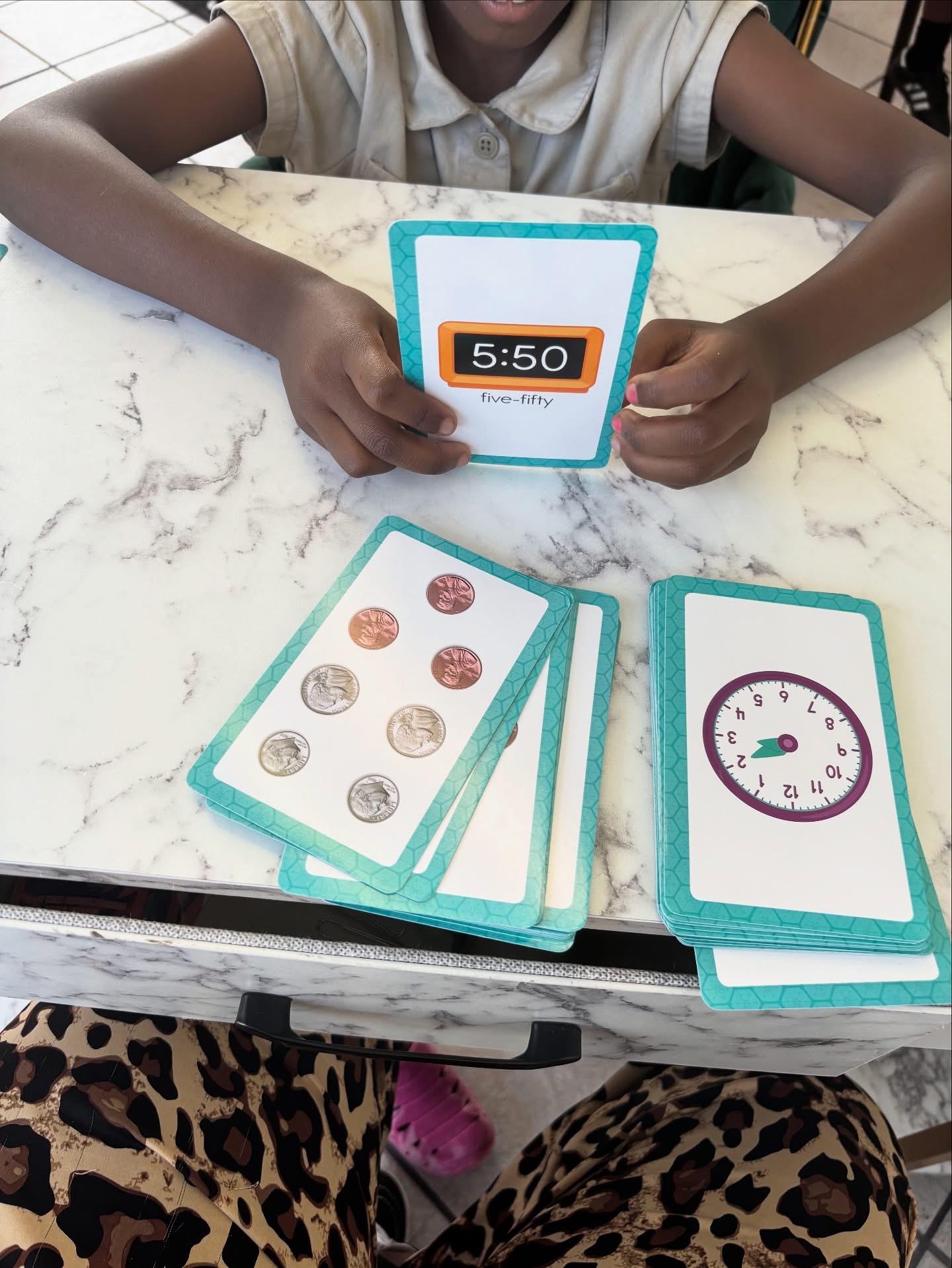 Student practicing telling time with flash cards